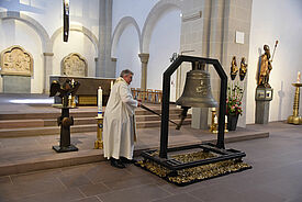 Msgr. Georg Austen schlägt die Friedensglocke von Michael Patrick Kelly.